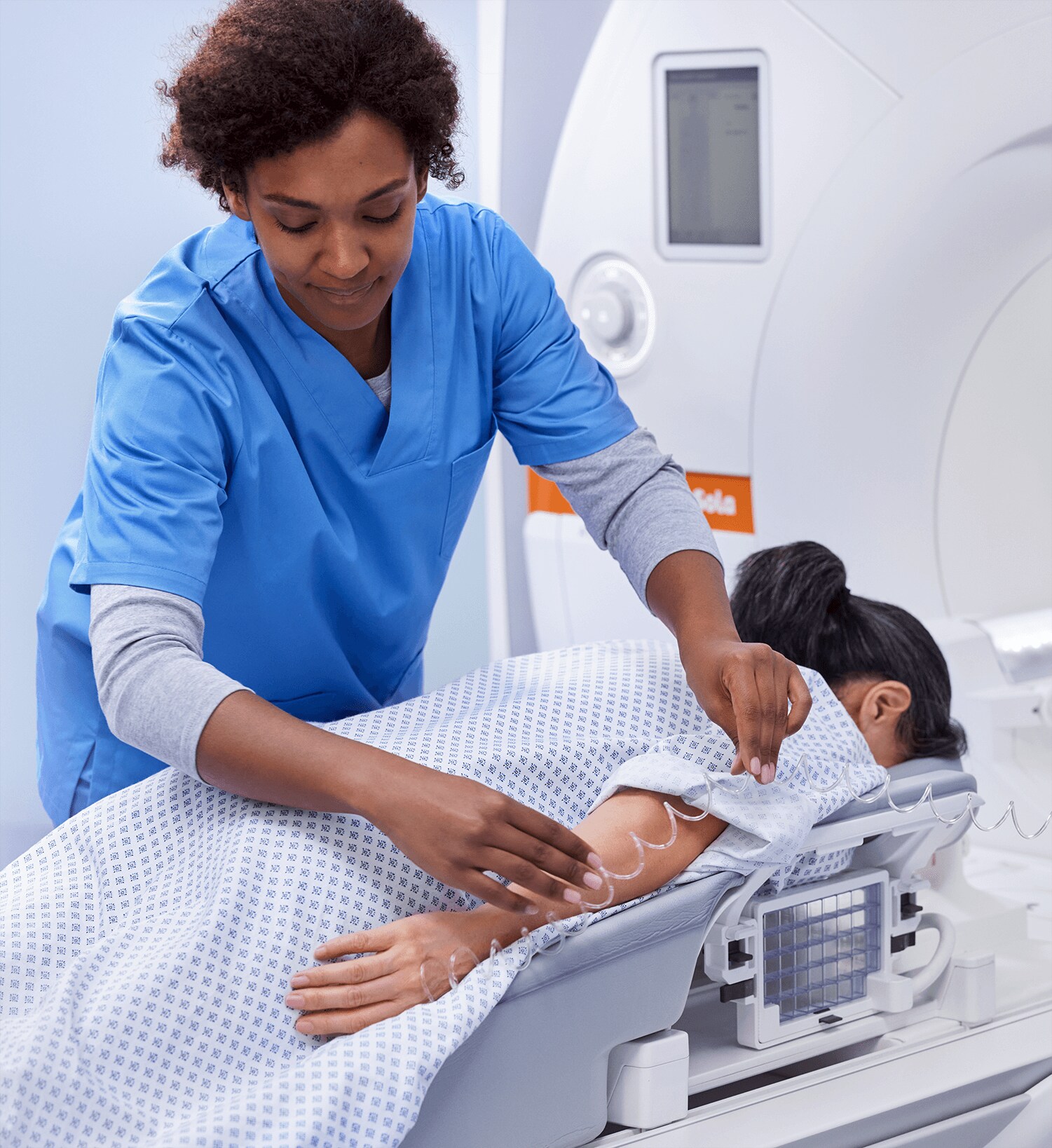 Healthcare professional performs breast MRI